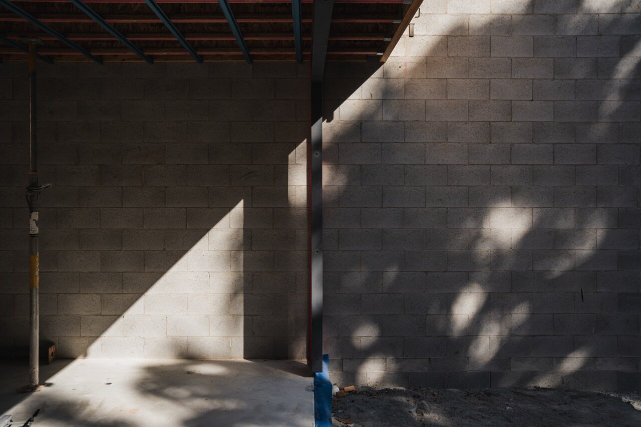 Light and shadow across detailed blockwork construction